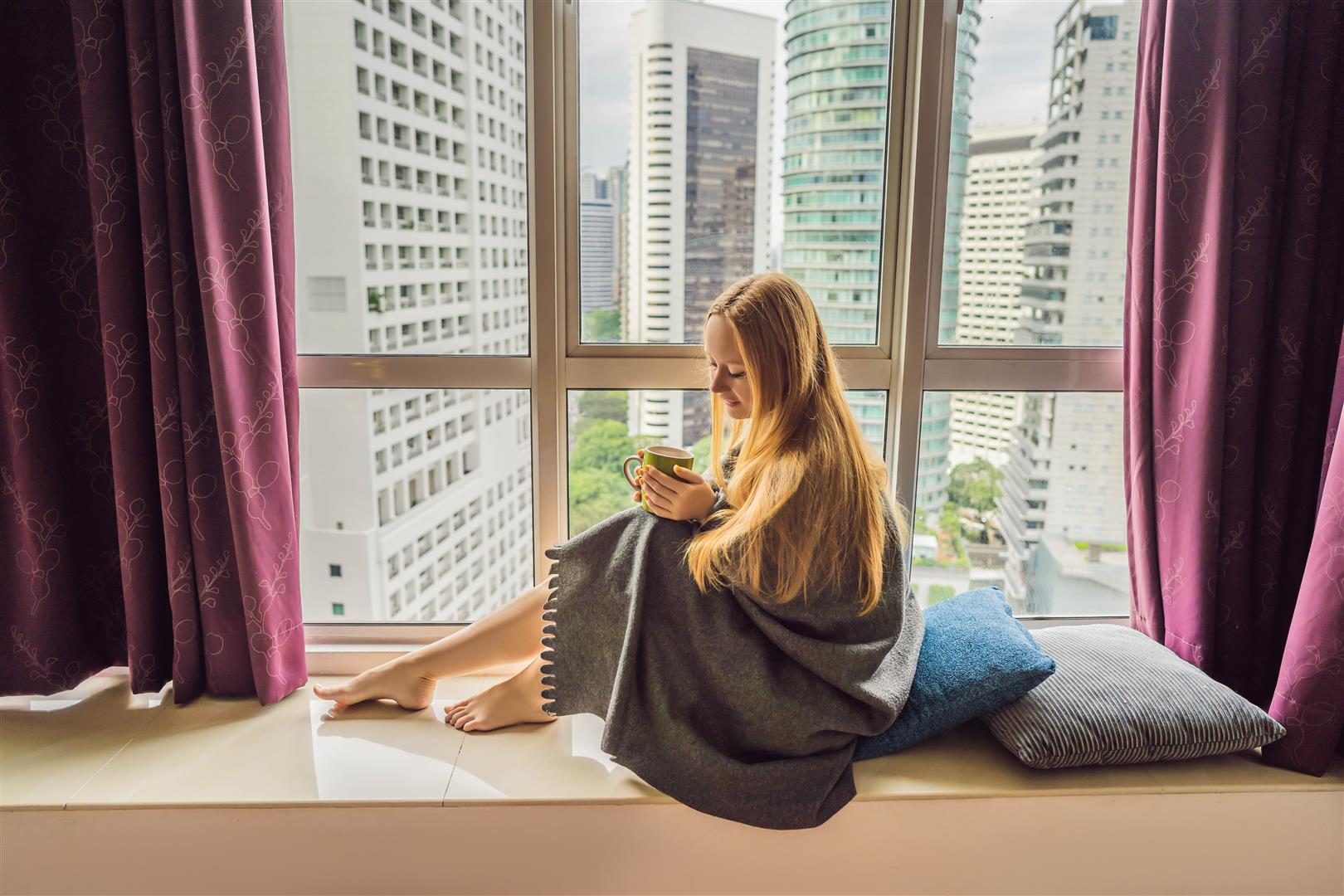 woman-wrapped-blanket-looking-big-city.jpg