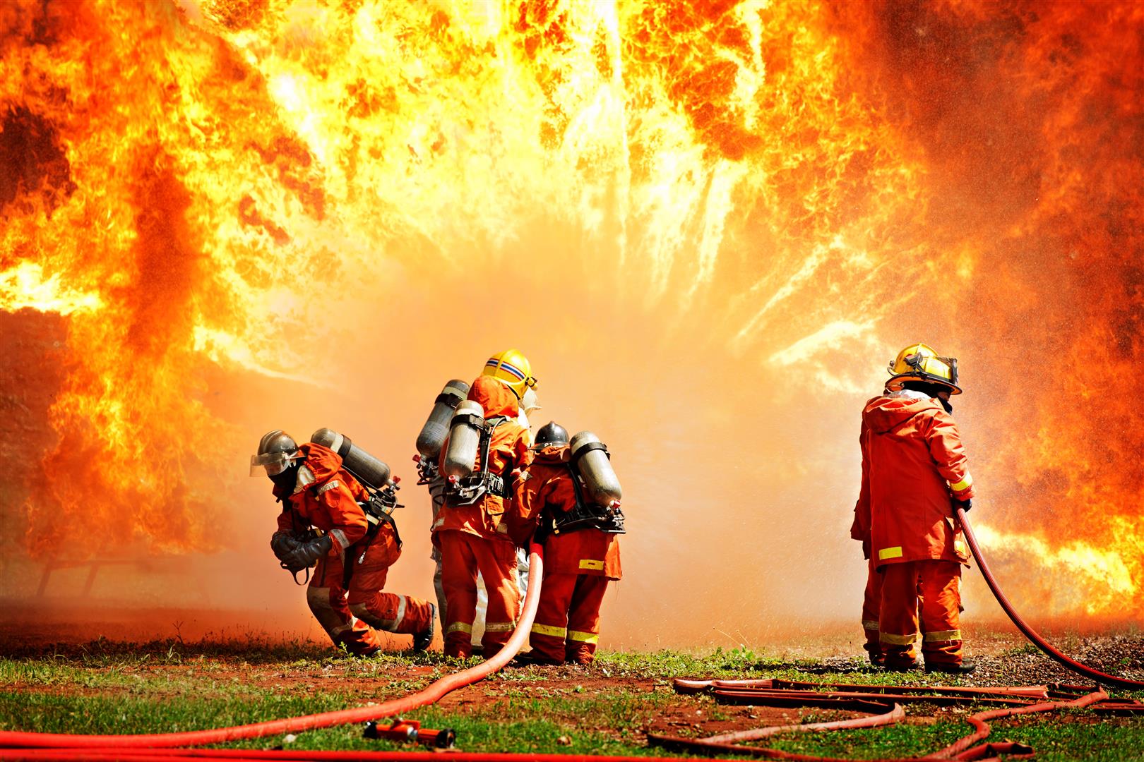 firemen-using-extinguisher-water-fighter-fire-during-firefight-training.jpg