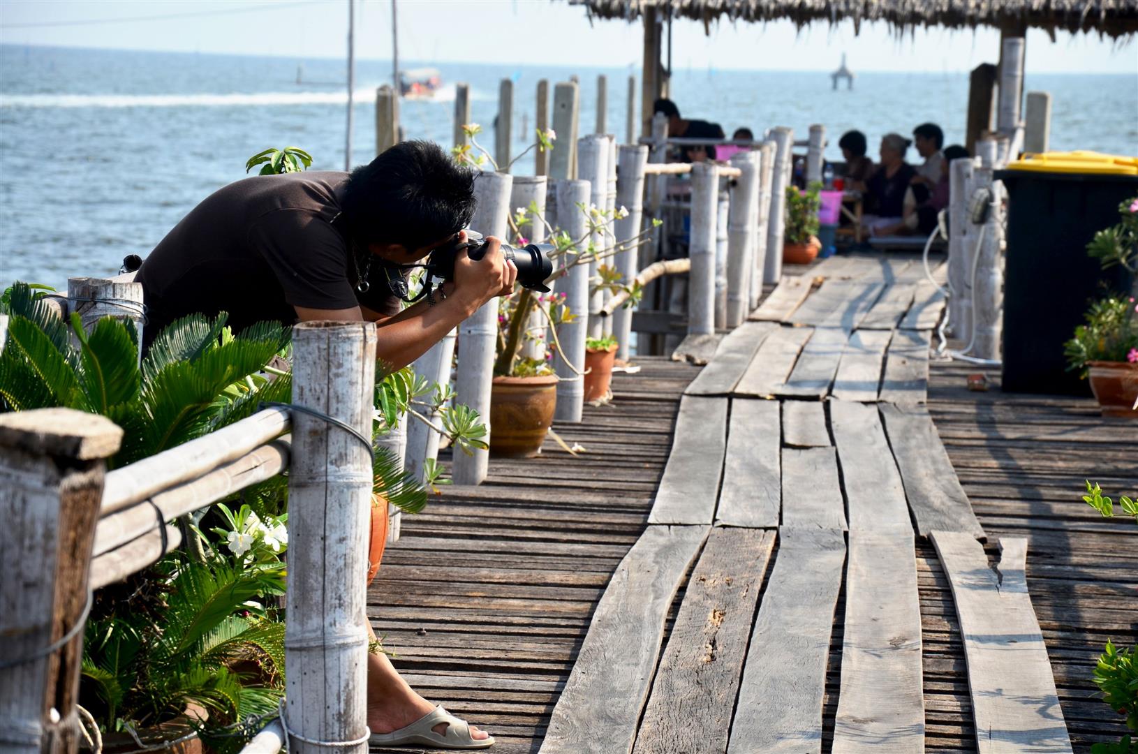 thai-man-photographer-people-shooting-take-photo-floating-local-restaurant-seaside-brackish-water-bangkhuntien-fishing-village-bang-khun-thian-city-urban-capital-bangkok-thailand.jpg